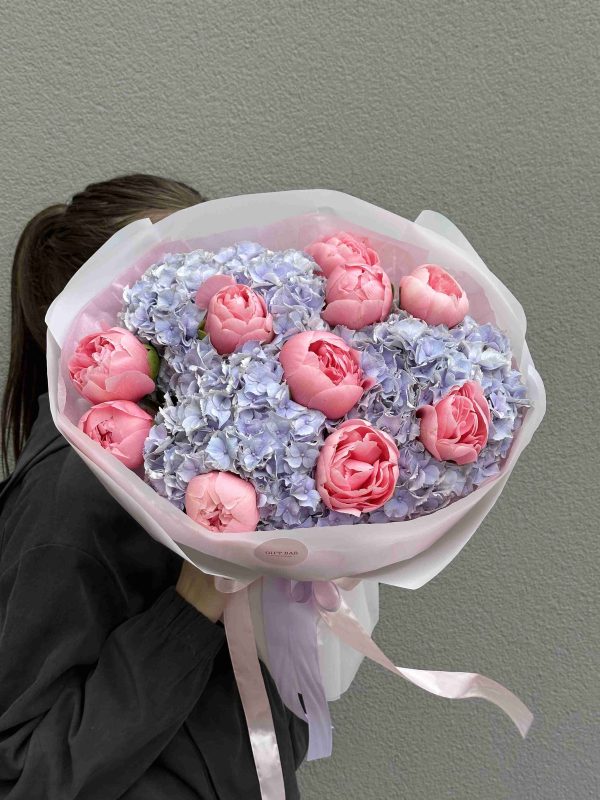 Bouquet of purple hydrangeas and Salmon peonies