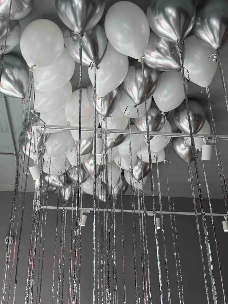 Silver and white latex balloons